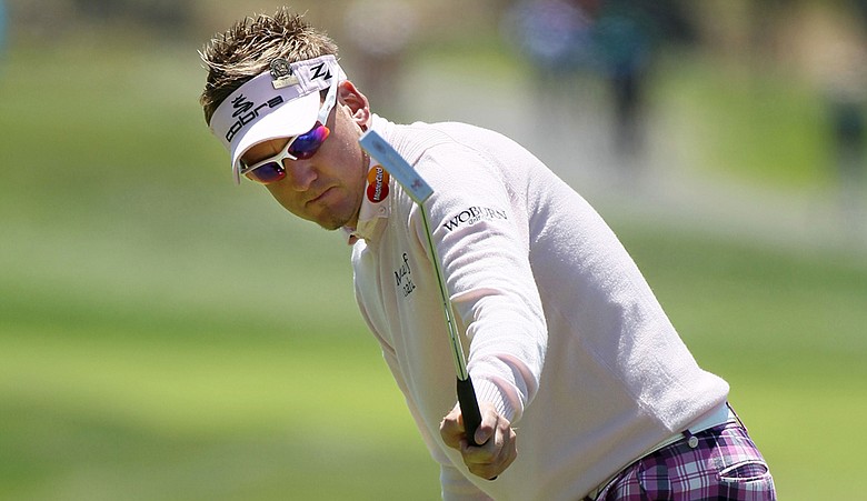 Ian Poulter watches a birdie putt at the 13th hole.