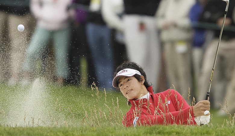 Ryo Ishikawa blasts out of a bunker on the 12th hole Friday at Pebble Beach.