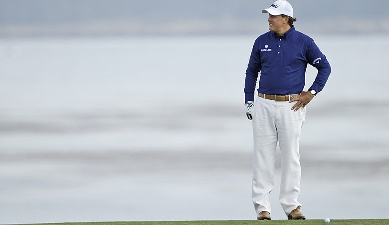 Phil Mickelson stands over a shot on the eighth hole Saturday at Pebble Beach.