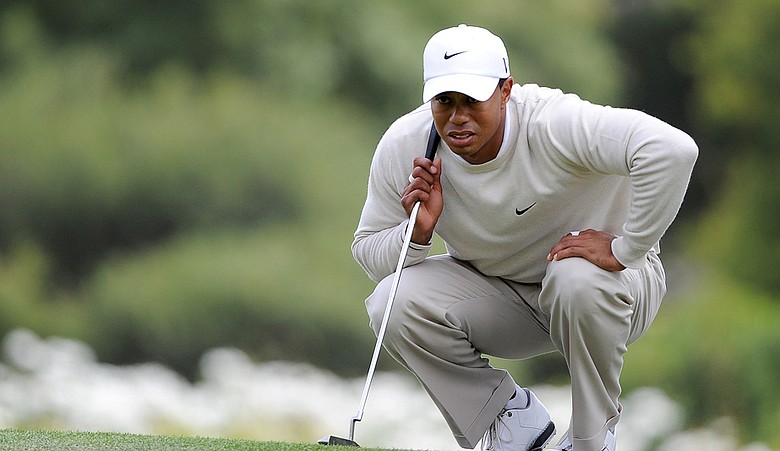 Tiger Woods reads a putt at the 14th.
