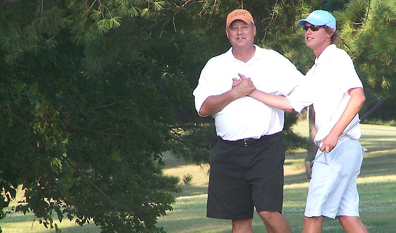Mickey Fisher congratulates son Ryne for winning his second Commanding General's title at Fort Campbell, Ky.
