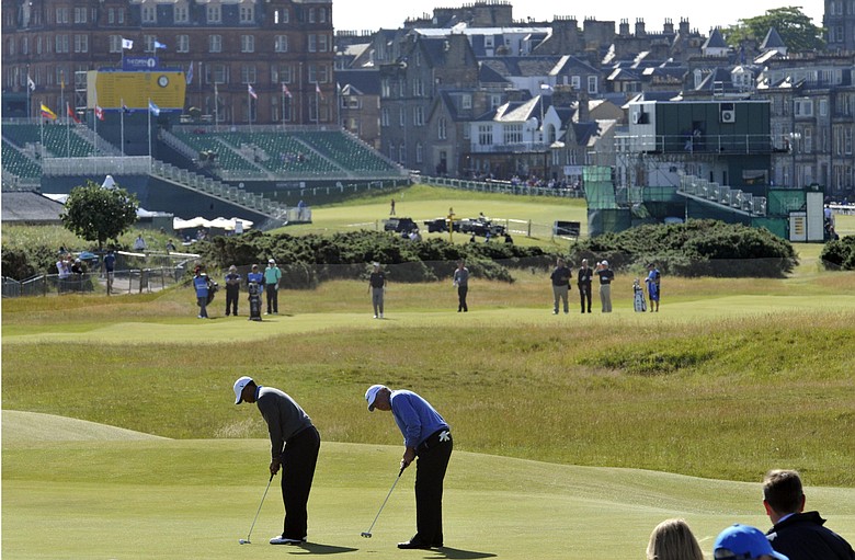 Tiger Woods and Mark O'Meara putt during a Monday practice round at St. Andrews.