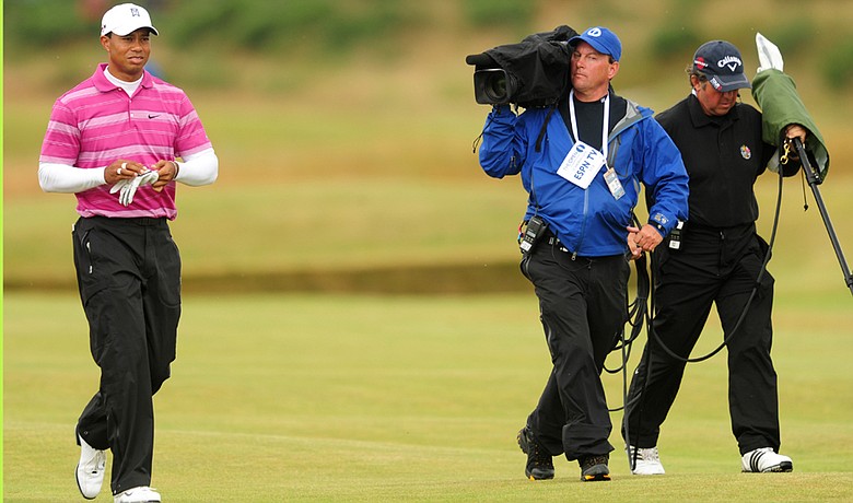 Tiger Woods is filmed by a film crew from ESPN during the first round of the the British Open.