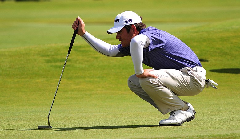 Louis Oosthuizen bends down to read a putt at the Old Course at St. Andrews.