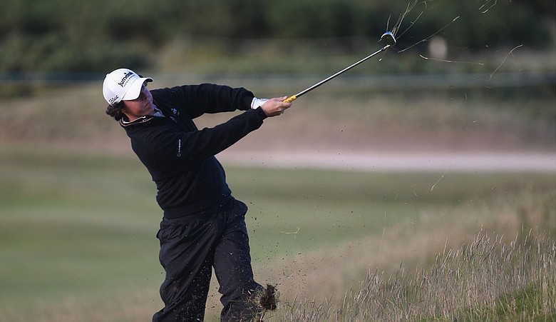 Rory McIlroy plays his second shot from an awkward lie on the 15th hole during the second round of the British Open.