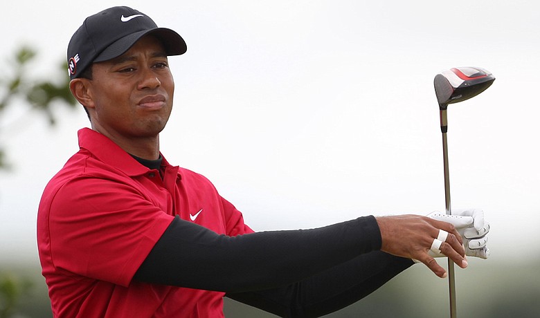 Tiger Woods watches his tee shot on the third tee during the final round of the British Open.