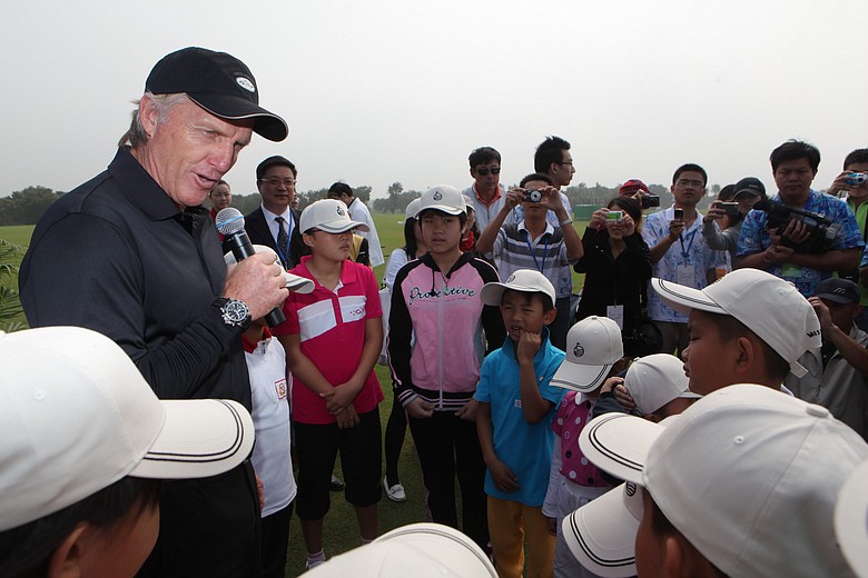 Greg Norman with junior golfers during a visit to Mission Hills Golf Club China.