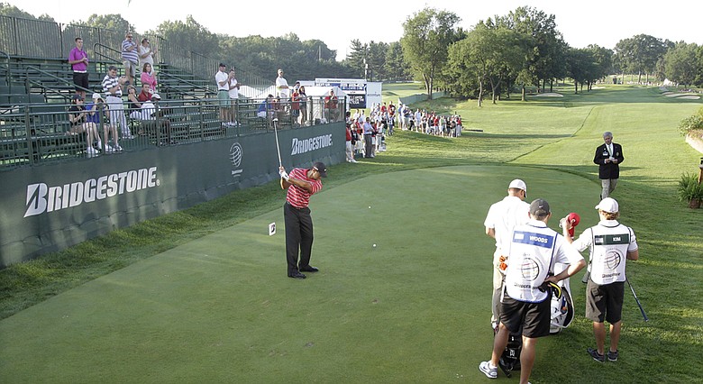 Tiger Woods has only a small gallery as he takes a practice swing before teeing off in the fourth round of the Bridgestone Invitational.