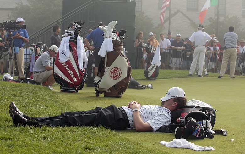 D.J. Trahan rests by the putting green during a fog delay before the first round of the PGA Championship.