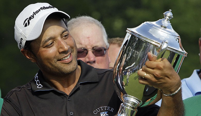 Arjun Atwal holds the Sam Snead Cup on the 18th green after winning the Wyndham Championship.