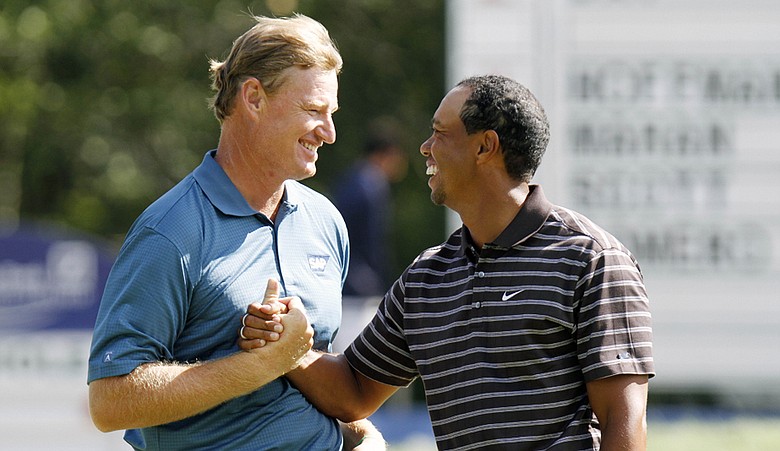 Tiger Woods and Ernie Els shake hands after finishing the third round of the Deutsche Bank Championship.