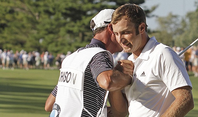 Dustin Johnson celebrates with his caddie Bobby Brown after winning the BMW Championship on Sept. 12, 2010.
