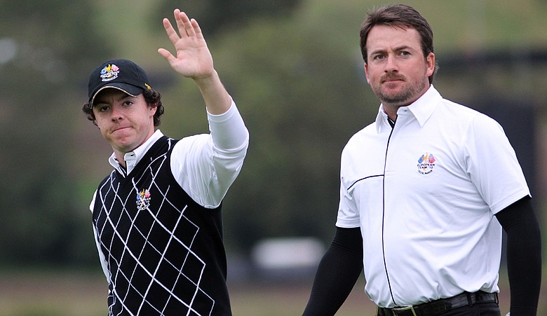 Rory McIlroy (left) waves to the crowd with teammate Graeme McDowell during the Sunday morning foursomes matches.