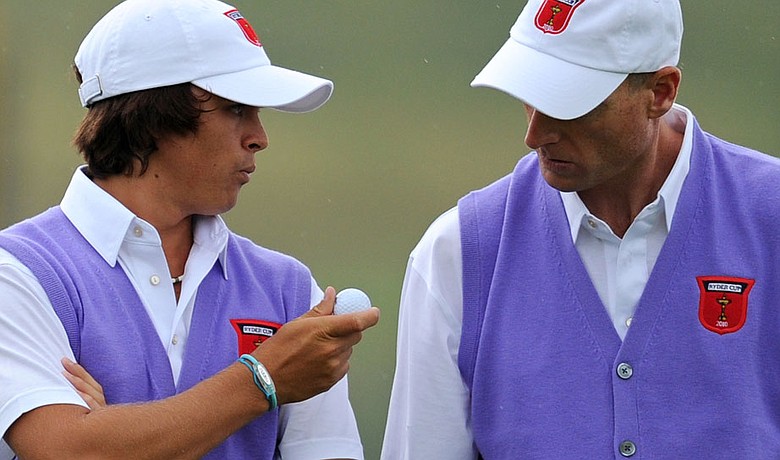 Rickie Fowler (left) speaks with partner Jim Furyk during the opening session of foursomes on the second day of the Ryder Cup.