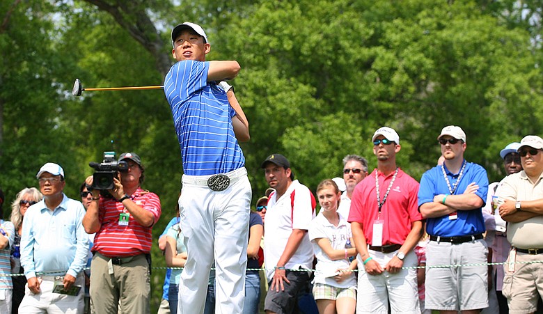 Anthony Kim tees off in front of a crowd at the Houston Open.