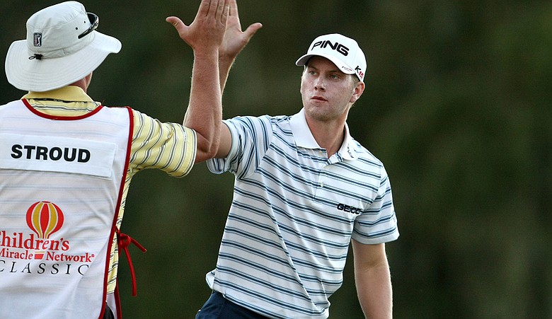 Chris Stroud high-fives his caddie during Round 1 of the Children's Miracle Network Classic.