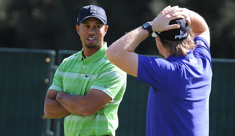 Tiger Woods chats with Hunter Mahan at the Chevron World Challenge.