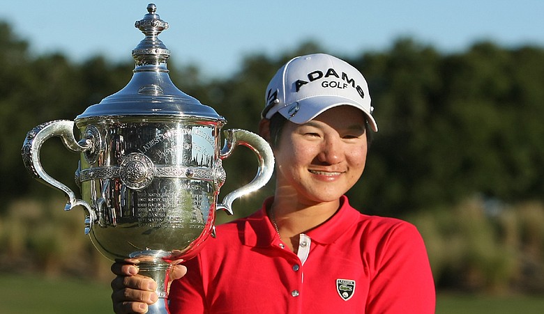 Yani Tseng poses with the Rolex Player of the Year trophy after the final round of the LPGA Tour Championship.