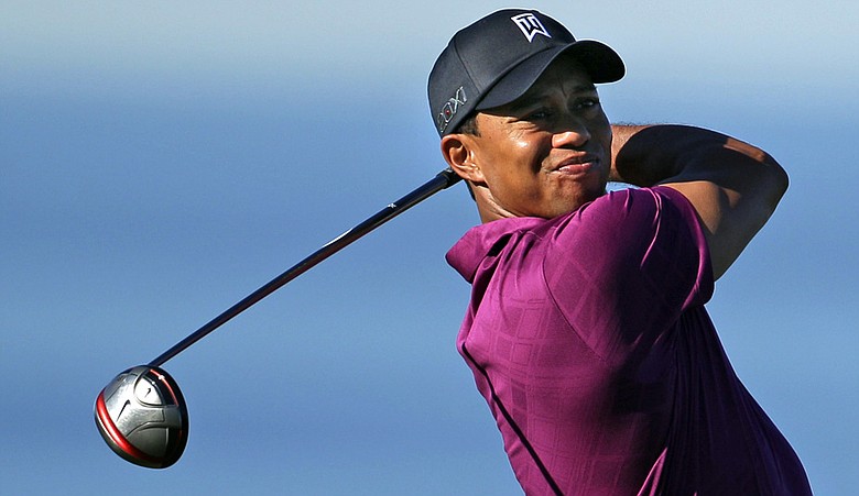 Tiger Woods watches his tee shot on the 13th hole of the North Course at Torrey Pines during the first round of the Farmers Insurance Open golf tournament in San Diego, Thursday, Jan. 27, 2011.