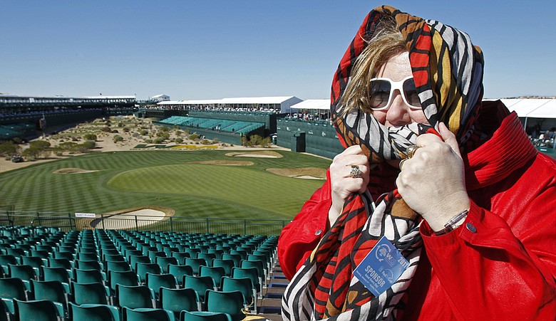 A spectator bundles up Wednesday at TPC Scottsdale