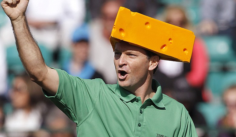 Wearing a Green Bay Packers "cheesehead," Mark Wilson cheers on the crowd at the 16th hole during the third round of the Waste Management Phoenix Open, which he went on to win in a playoff over Jason Dufner.