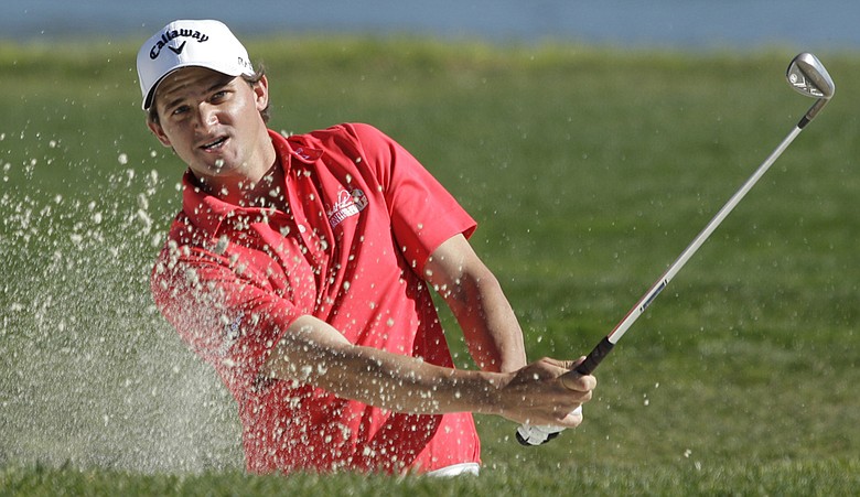 Sam Saunders follows his shot from the bunker onto the 17th green during the second round of the AT&T Pebble Beach National Pro-Am golf.