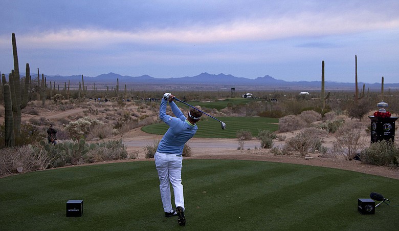 Luke Donald tees off on the first hole at the Ritz-Carlton Club at Dove Mountain in Marana, Ariz.