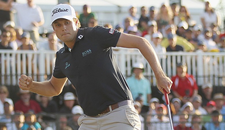 Nick Watney celebrates his birdie putt on the 18th green during the final round of the 2011 WGC-Cadillac Championship at the TPC Blue Monster at the Doral Golf Resort and Spa.