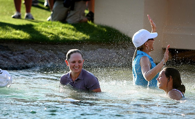 Stacy Lewis and her family celebrate in Poppie's Pond after she won during the final round of the the 2011 Kraft Nabisco Championship.