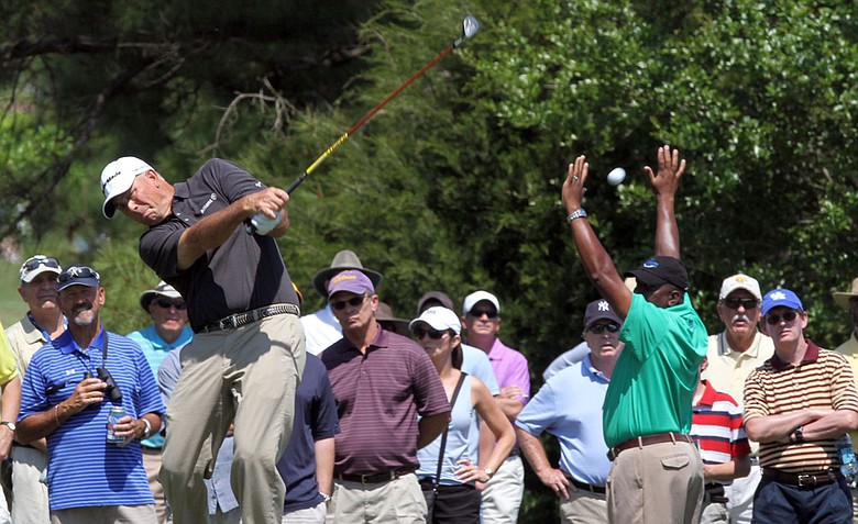 Fans watch as Tom Lehman drives his ball toward first hole at the Mississippi Gulf Resort Classic at Fallen Oak Saturday. The first shot by Lehman sent fans scurrying as it sailed off of the fareway and into the crowd.