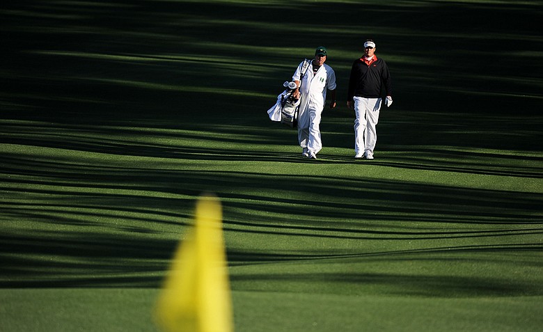 Jeff Overton walks up the second fairway with his caddie Eric Larson during the first round of the 2011 Masters Tournament at Augusta National Golf Club on April 7, 2011 in Augusta, Georgia.