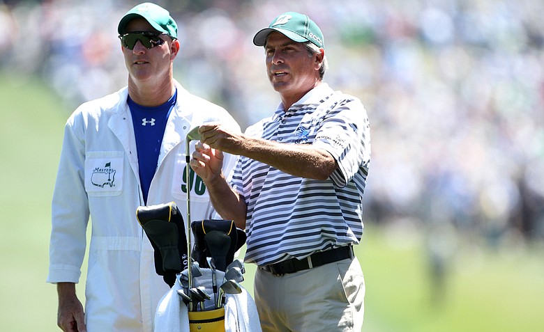 Fred Couples talks with his caddie Joe LaCava on the first hole during the first round of the 2011 Masters Tournament. LaCava has also worked for Dustin Johnson and will reportedly move to Tiger Woods' bag.