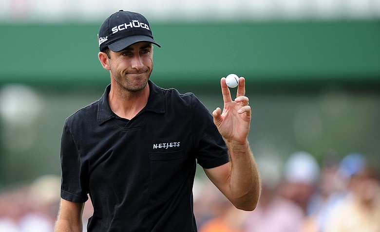 Geoff Ogilvy waves to the crowd on the 17th green during the second round of the 2011 Masters.
