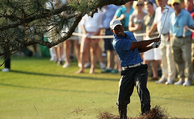 Tiger Woods punches out from beneath a tree at Augusta's 17th.