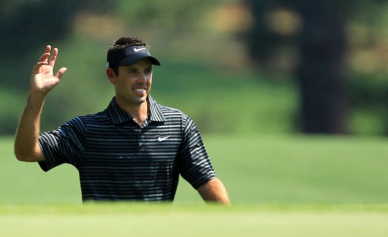 Charl Schwartzel of South Africa waves to the gallery after holing a shot for eagle on the third green during the final round of the 2011 Masters Tournament on April 10, 2011 in Augusta, Georgia.