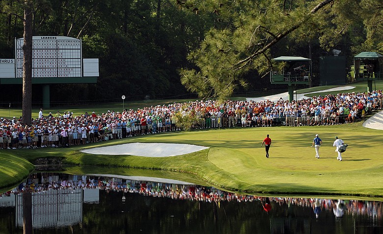 Tiger Woods walks with his caddie Steve Williams and Martin Laird to the 16th green during the final round of the 2011 Masters.