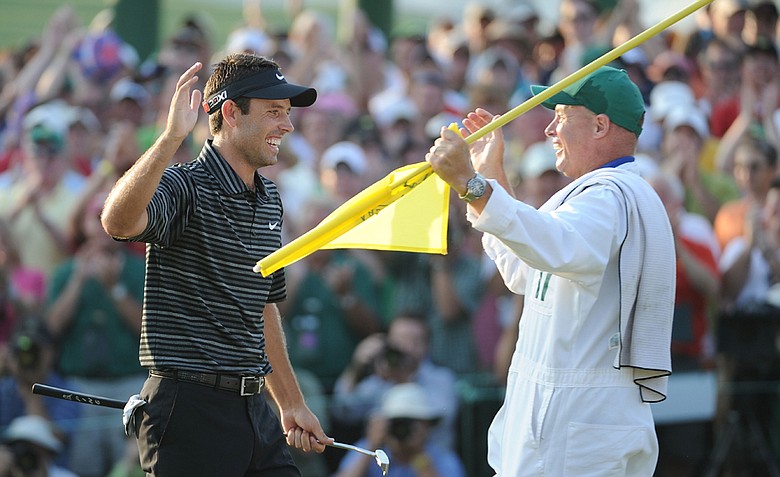 Charl Schwartzel high fives his caddie Greg Hearmon after winning the Masters on Sunday.
