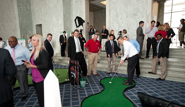Attendees taking part in the We Are Golf exhibit in the Rayburn Foyer during the observance of National Golf Day in Washington, D.C., on Wednesday, April 13th, 2011.