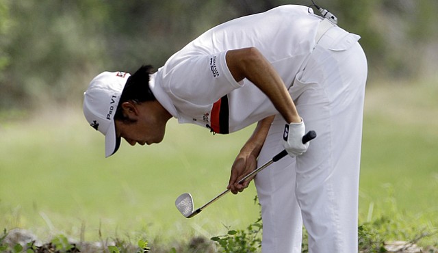 Kevin Na looks at his lie on the eighth hole during the first round of the Texas Open.