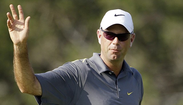 Stewart Cink waves after a birdie putt on the ninth hole during the first round of the Texas Open.
