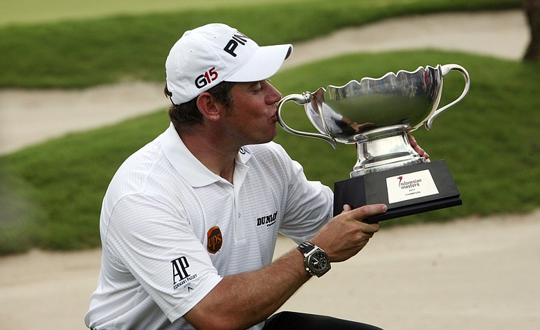 Lee Westwood of England kiss the trophy after winning the Indonesian Masters golf tournament at Royale Jakarta Golf Club in Jakarta, Indonesia,Sunday, April 24, 2011.