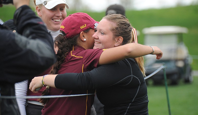 Minnesota's Teresa Puga, left, hugs teammate Samantha Sommers after the Golden Gophers advanced to the NCAA Division I championship.