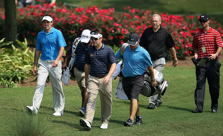 South African players Charl Schwartzel, left, and Louis Oosthuizen walk to the 13th green during Tuesday's practice round at The Players Championship at TPC Sawgrass.