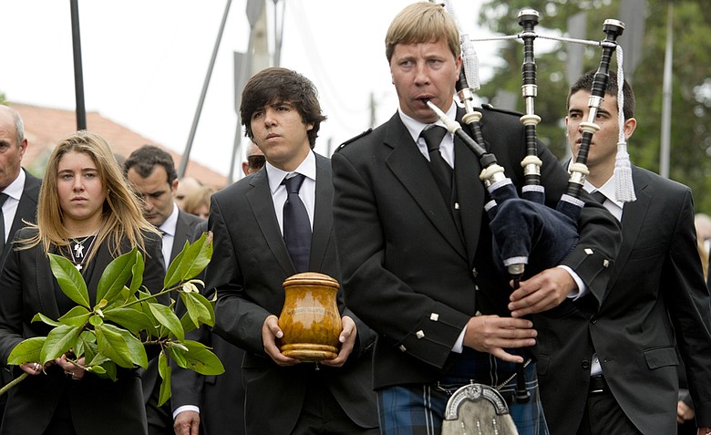 A bagpiper leads the funeral procession for Spanish golfer Seve Ballesteros, whose ashes are carried by oldest son Javier, with sister Carmen (left) and brother Miguel (right) joining the mourners Wednesday in Pedrena, Spain. Ballesteros, 54, a five-time major champion, died Saturday from complications of a cancerous brain tumor.