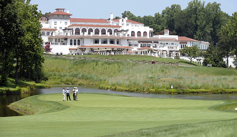 U.S. Open officials, lower left, inspect the 18th green at Congressional Country Club in Bethesda, Md., Friday, July 23, 2010.