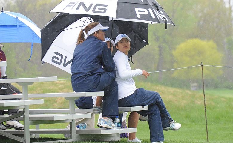 UCLA coach Carrie Forsyth and Stephanie Kono watch the Bruins finish at the 2011 NCAA Women's Regional in Indiana.
