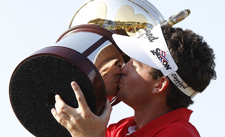 Keegan Bradley kisses the Byron Nelson Championship trophy after winning the golf tournament in Irving, Texas, Sunday, May 29, 2011.