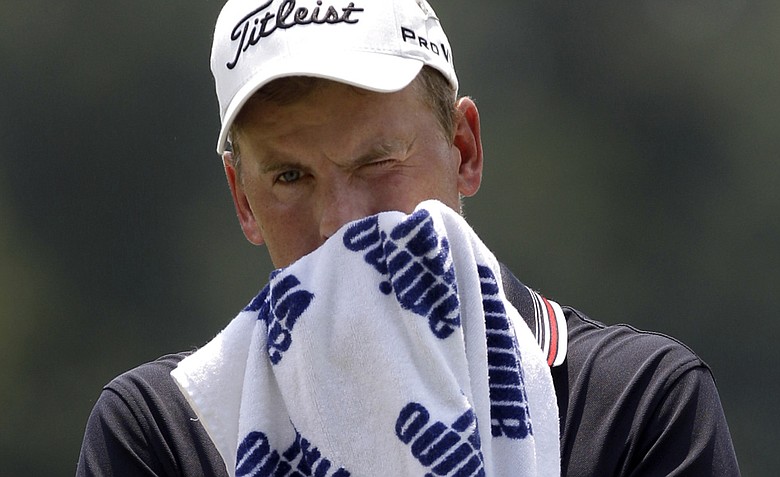 Robert Karlsson, of Sweden, towels off after putting for par on the second hole during the third round of the St. Jude Classic golf tournament Saturday, June 11, 2011, in Memphis, Tenn.