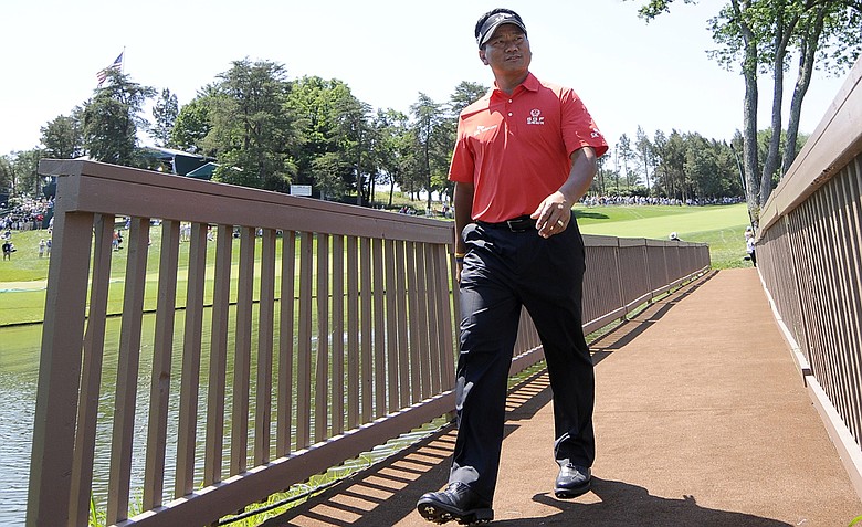 K. J. Choi, of South Korea, walks across the players bridge from the 18th green during a practice round for the U.S. Open Championship golf tournament in Bethesda, Md., Wednesday, June 15, 2011.