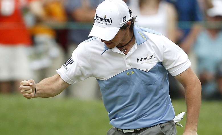 Rory McIlroy, of Northern Ireland, reacts after making his birdie putt on the 11th hole during the third round of the U.S. Open Championship golf tournament in Bethesda, Md., Saturday, June 18, 2011.